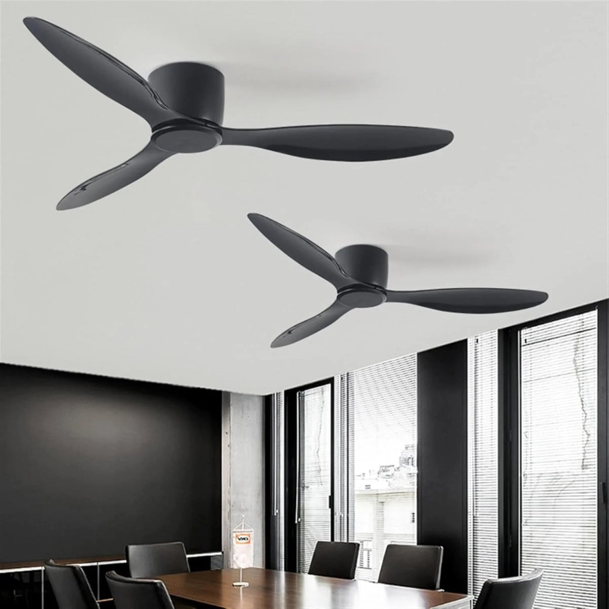 Two black ceiling fans in a modern room with large windows.