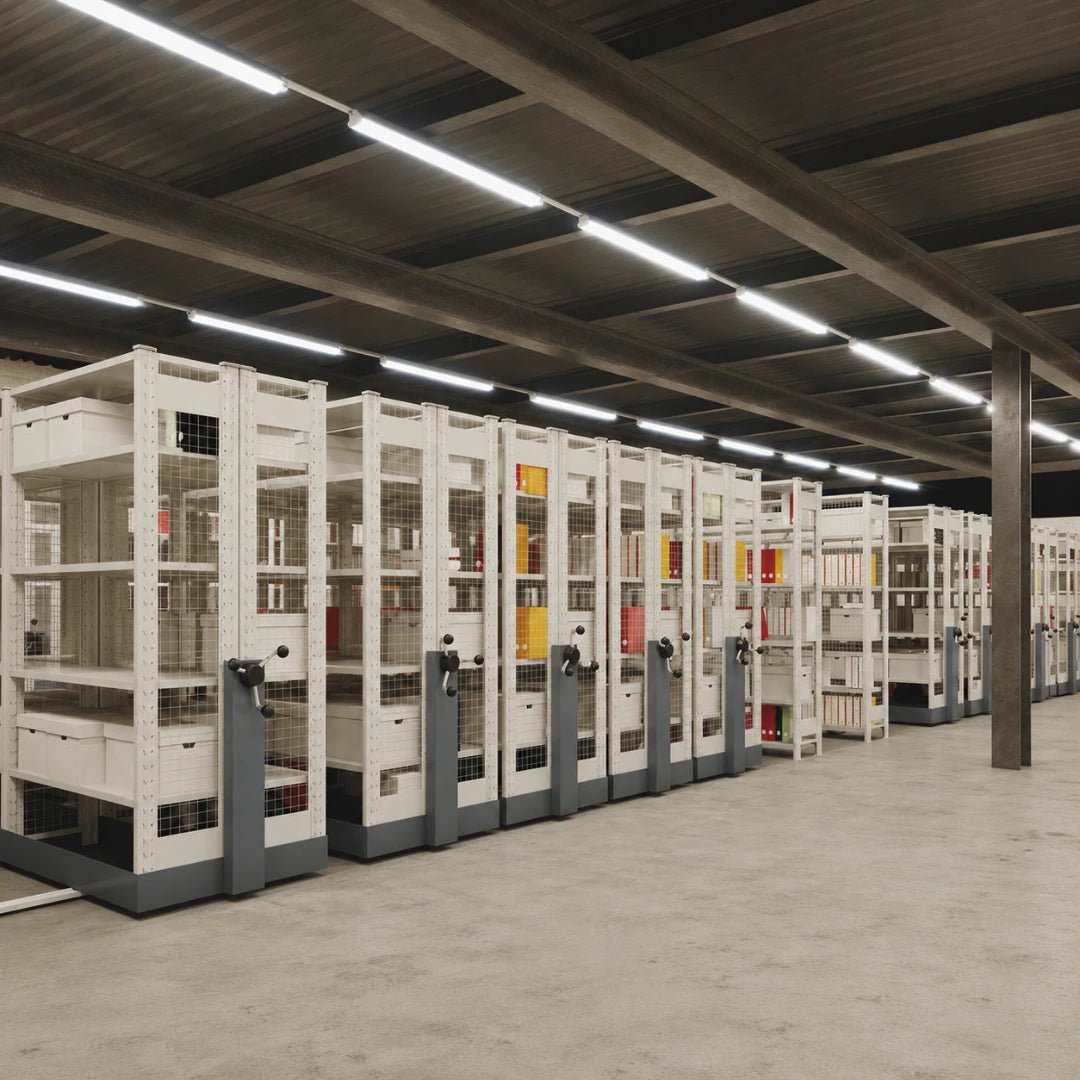 Row of storage shelves in a warehouse setting with a concrete floor and metal beams.