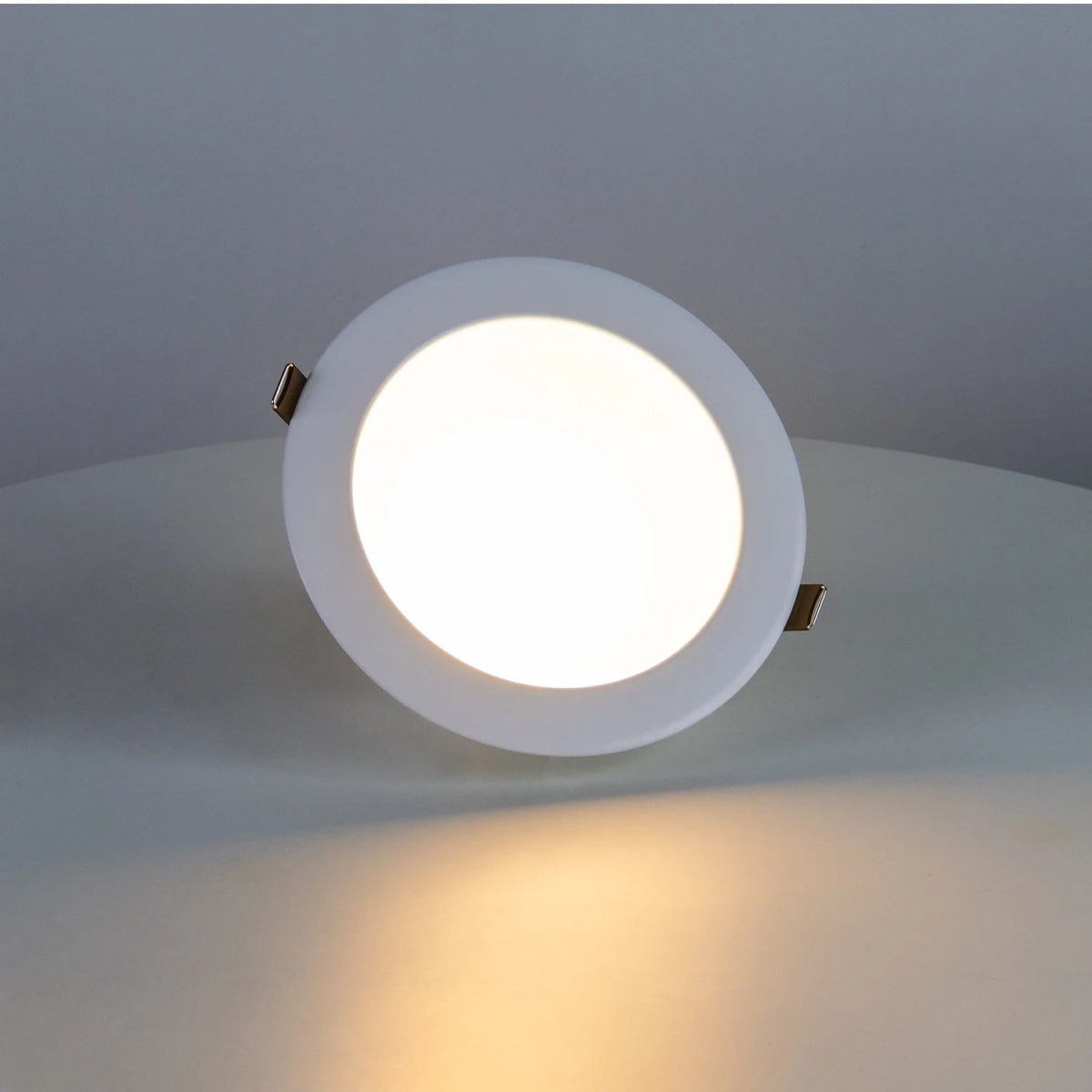 Round recessed ceiling light fixture on a neutral background