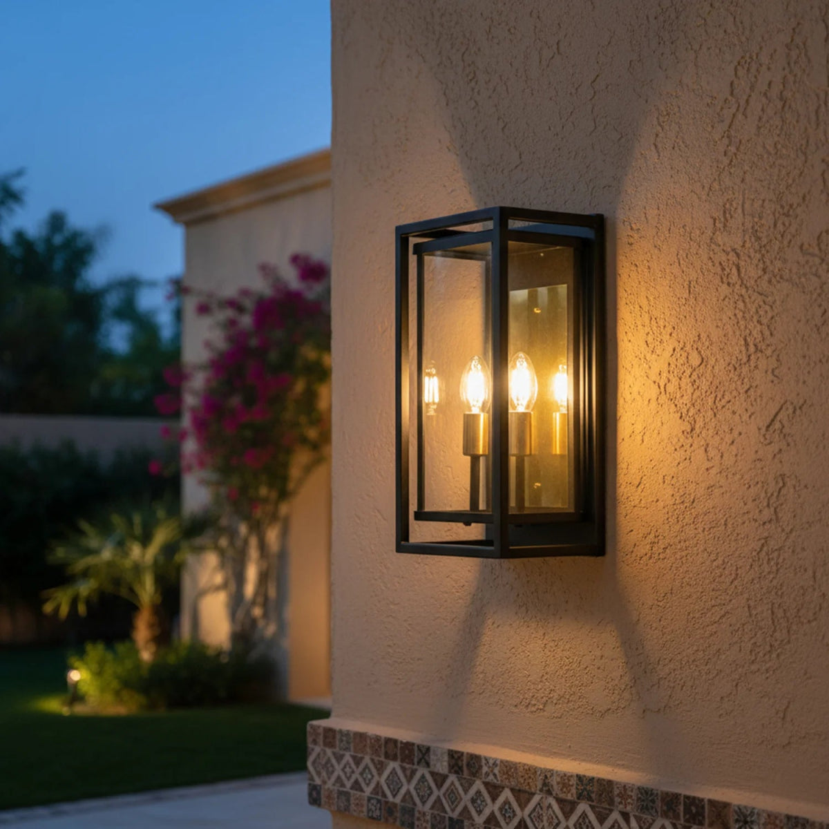 Outdoor wall light fixture on a textured wall with blurred garden background