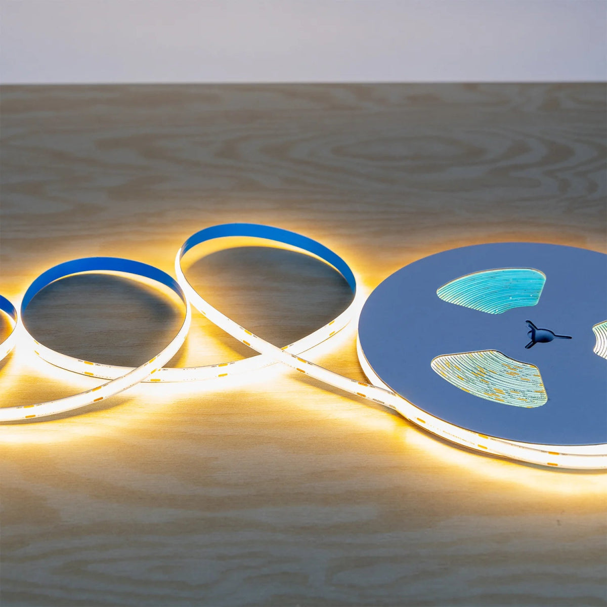 LED strip lights on a wooden surface with a white background