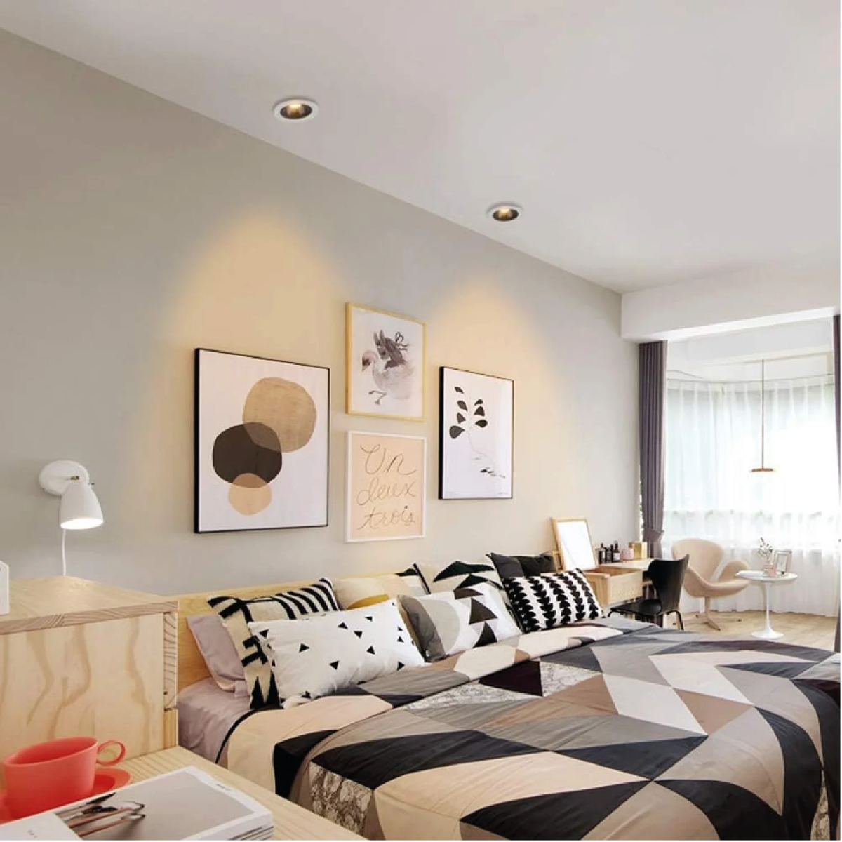 Modern bedroom with a bed, pillows, and wall art