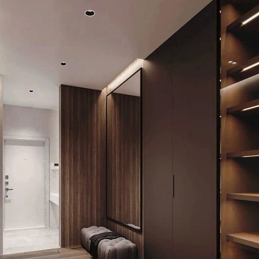Modern interior with a mirror, bench, and wooden wall.