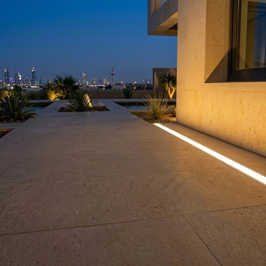 Evening view of a modern building with illuminated pathways and trees.