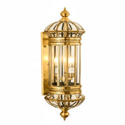 Decorative gold wall-mounted light fixture on a white background