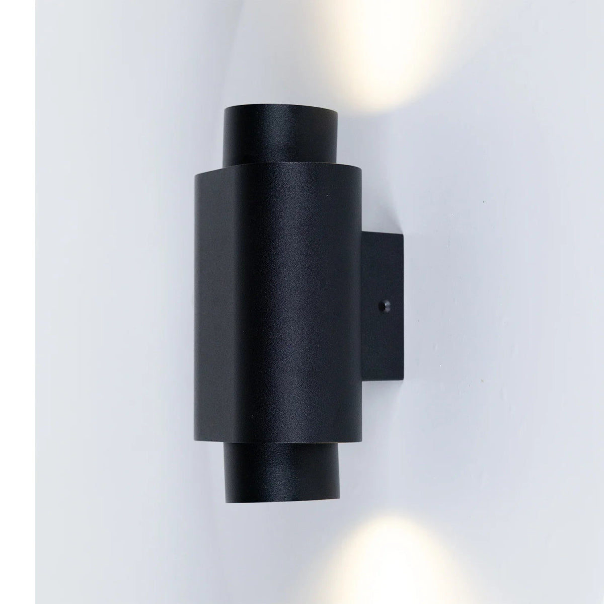 Black wall-mounted outdoor light fixture on a white background