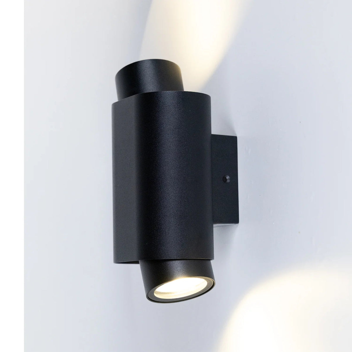 Black outdoor wall light fixture on a white background