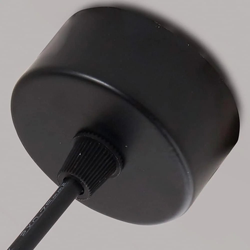 Black cylindrical device with a cable on a gray background