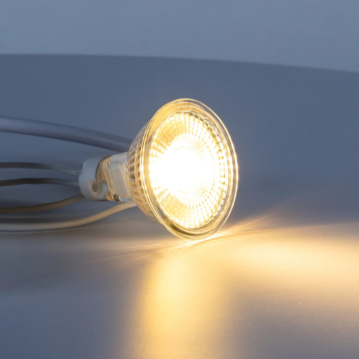 LED light bulb emitting a warm glow on a dark background