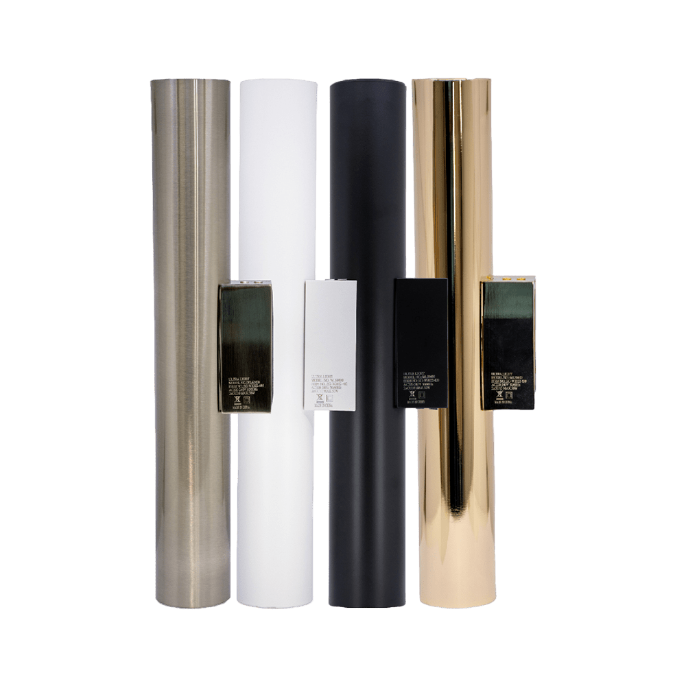 Five rolls of metallic paper in different colors on a green background