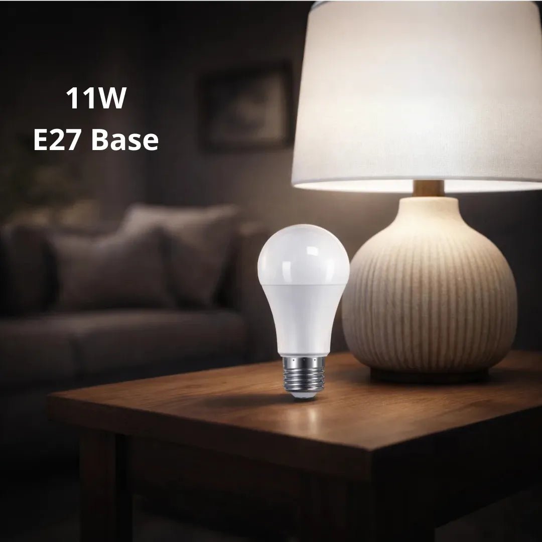 11W E27 base LED bulb on a table with a lamp in the background