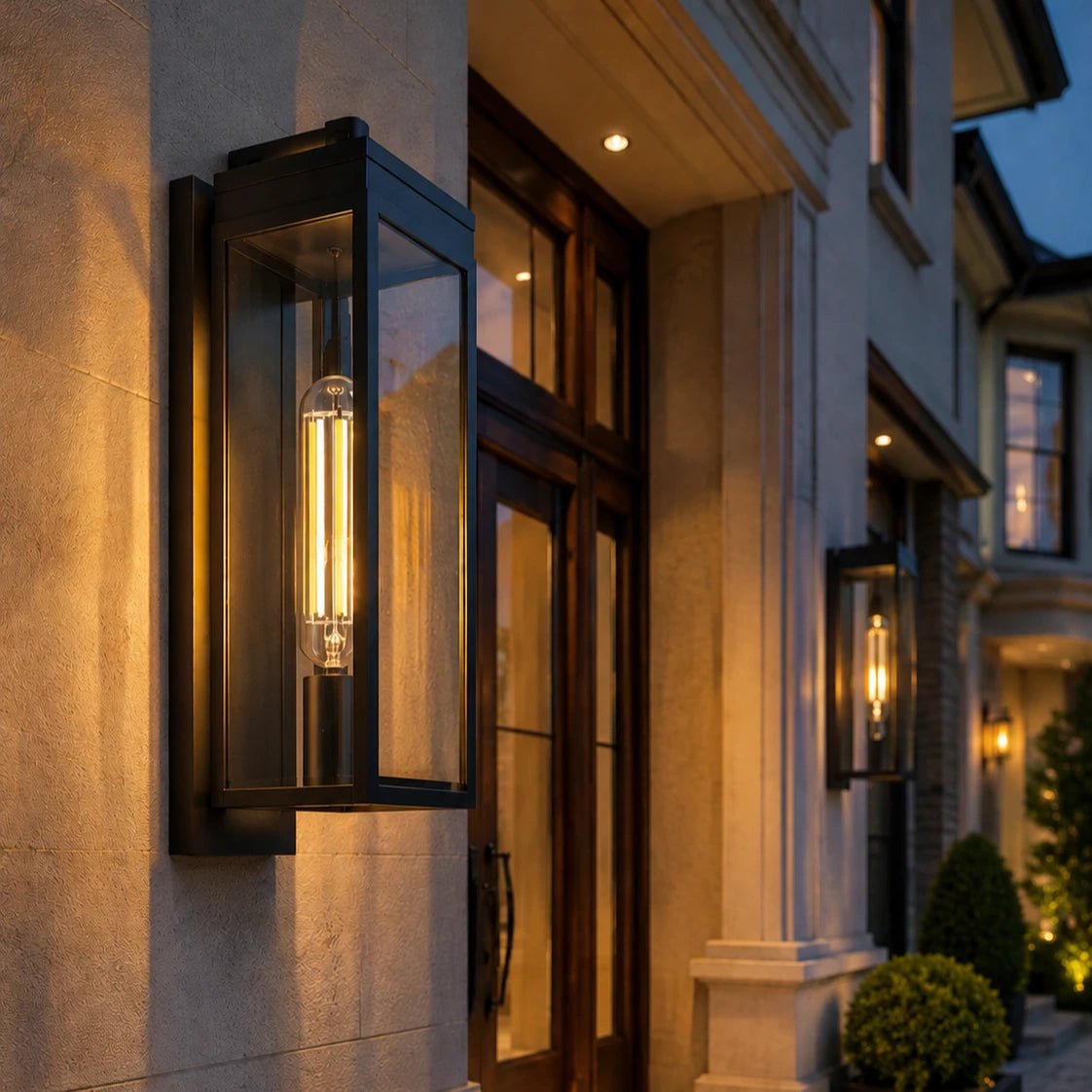 Decorative outdoor wall lights on a building facade at night.