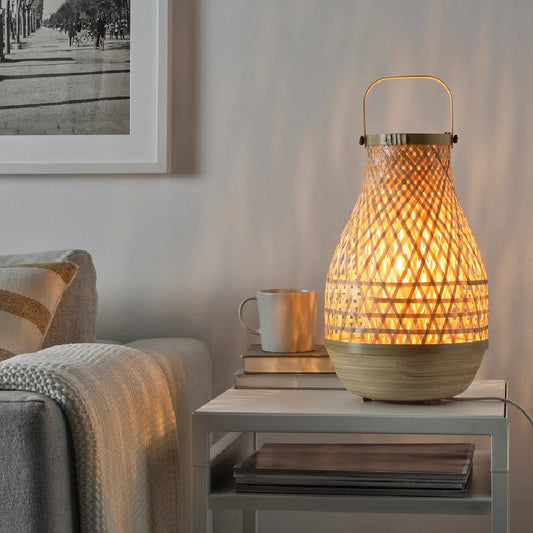 Woven table lamp on a side table with a cozy living room setting.