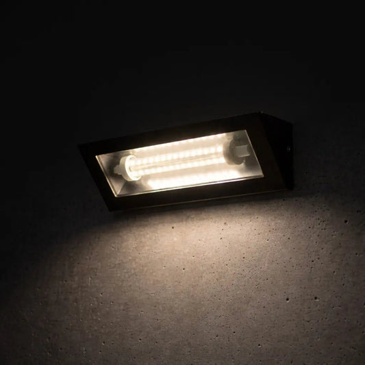 Rectangular light fixture emitting a warm glow on a dark surface