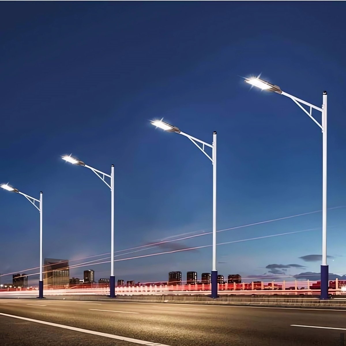 Streetlights along a road at night with a clear blue sky