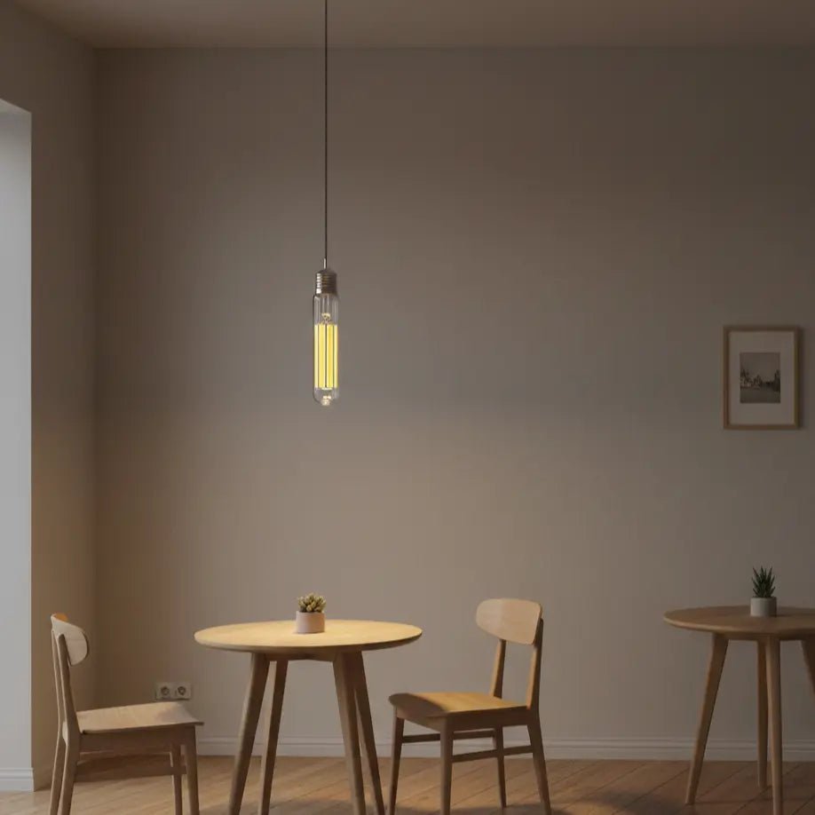 Modern dining room with wooden table and chairs, illuminated by a hanging light bulb.