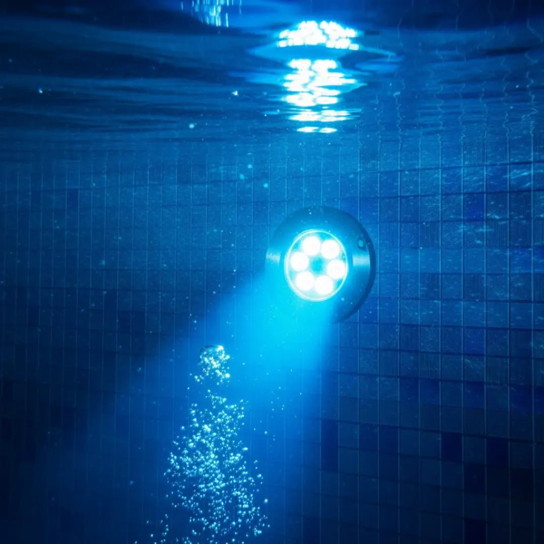 Underwater light fixture in a pool with tiled walls