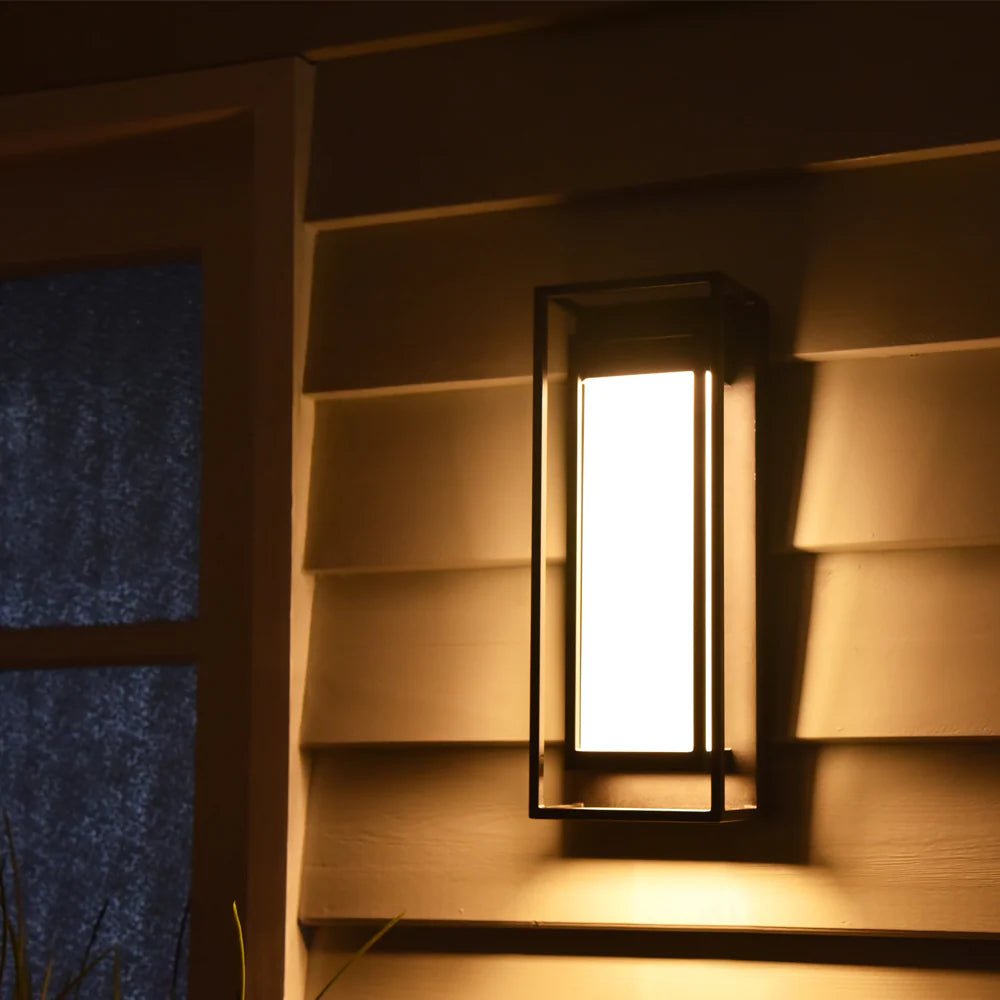 Wall-mounted light fixture casting a warm glow on a wooden wall.