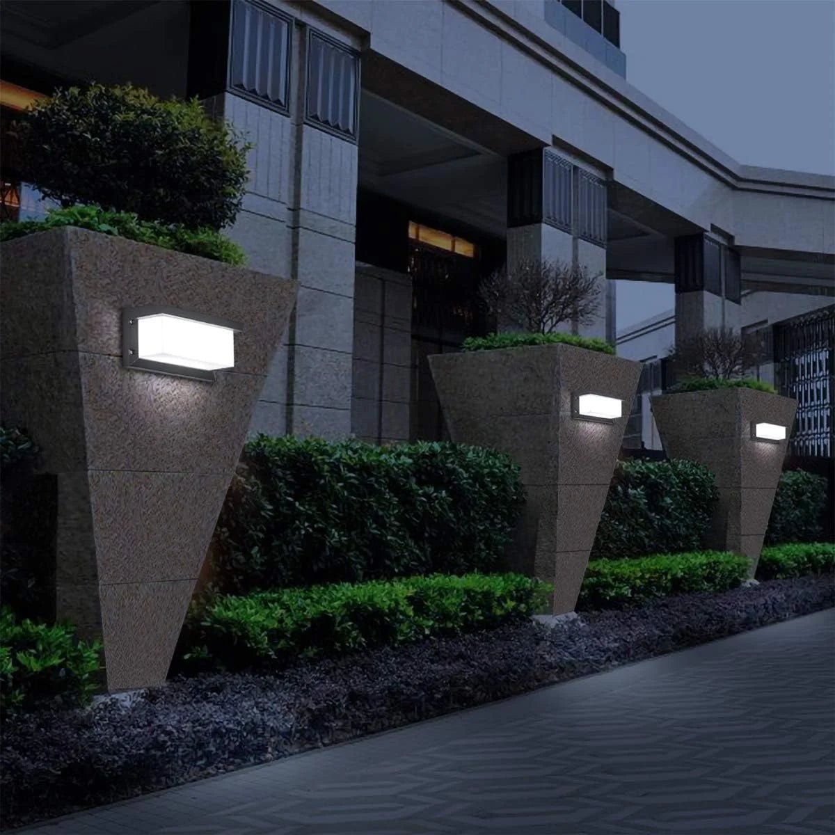 Ultralight LED Wall Sconce (BD3112) mounted on outdoor stone planters providing modern, soft, energy-efficient lighting.