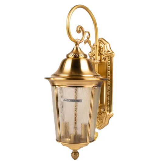 Gold outdoor wall lantern with decorative design on a white background