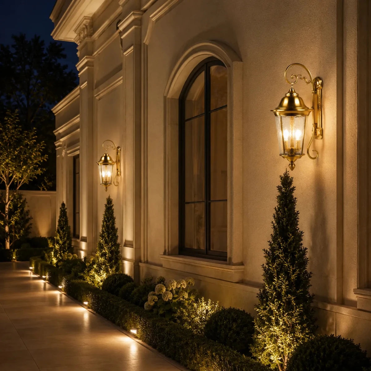 Decorative outdoor lighting fixtures on a building facade with illuminated plants.
