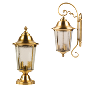 Two gold outdoor wall lights with glass shades on a white background
