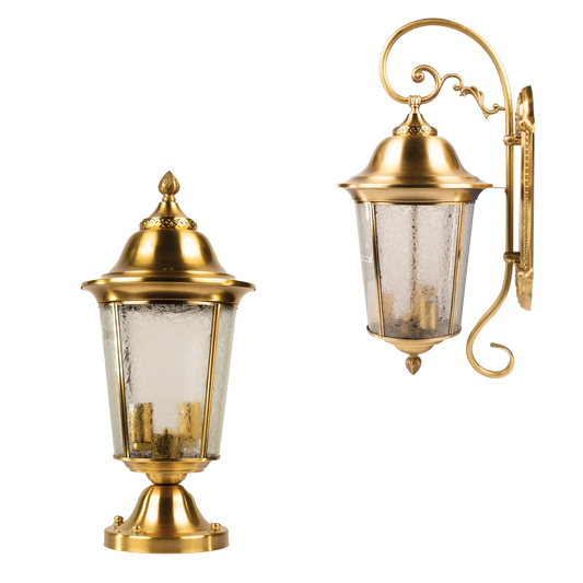 Two gold outdoor wall lights with glass shades on a white background