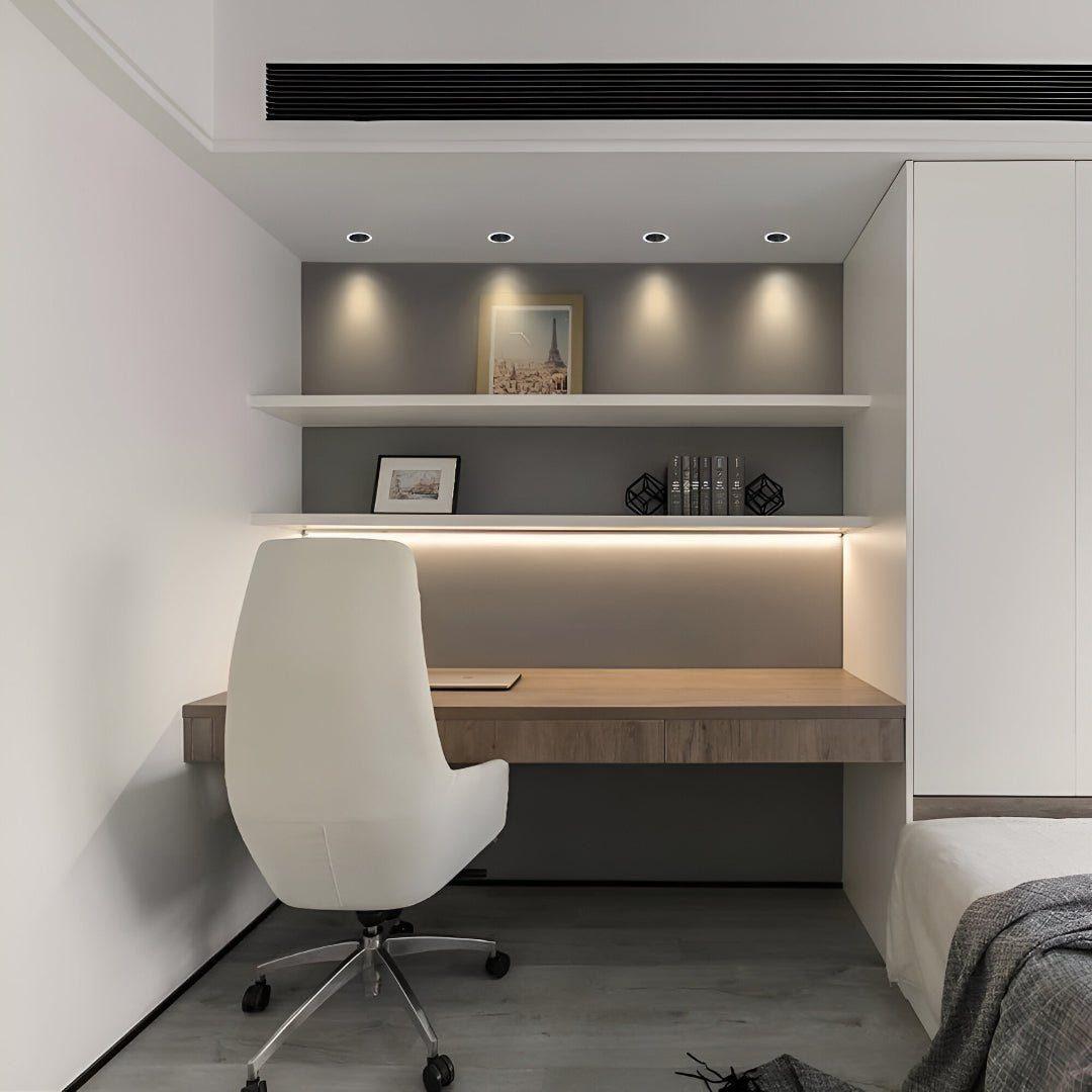 Modern bedroom with a desk and chair, shelves, and lighting fixtures.