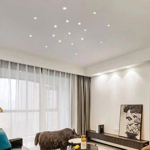 Modern living room with ceiling lights, curtains, and a TV stand.