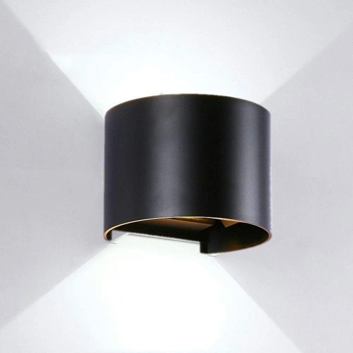 Black cylindrical wall light fixture on a white background