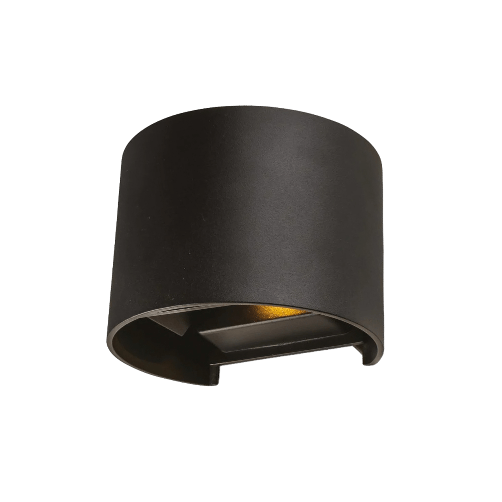 Black wall-mounted light fixture on a green background