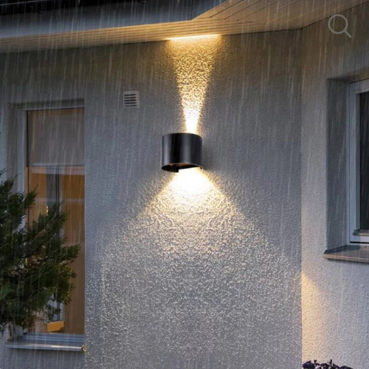 Outdoor wall light fixture on a textured house exterior