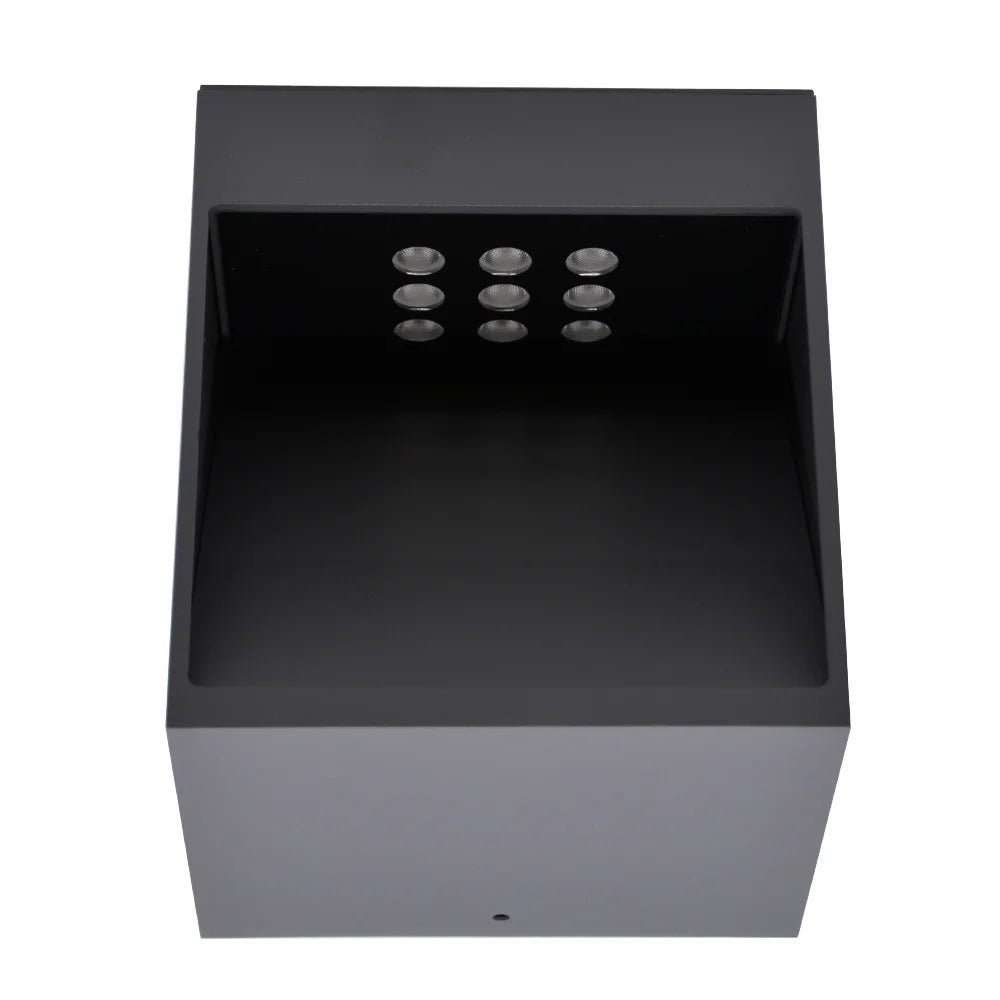 Black rectangular light fixture with six circular lights on a white background