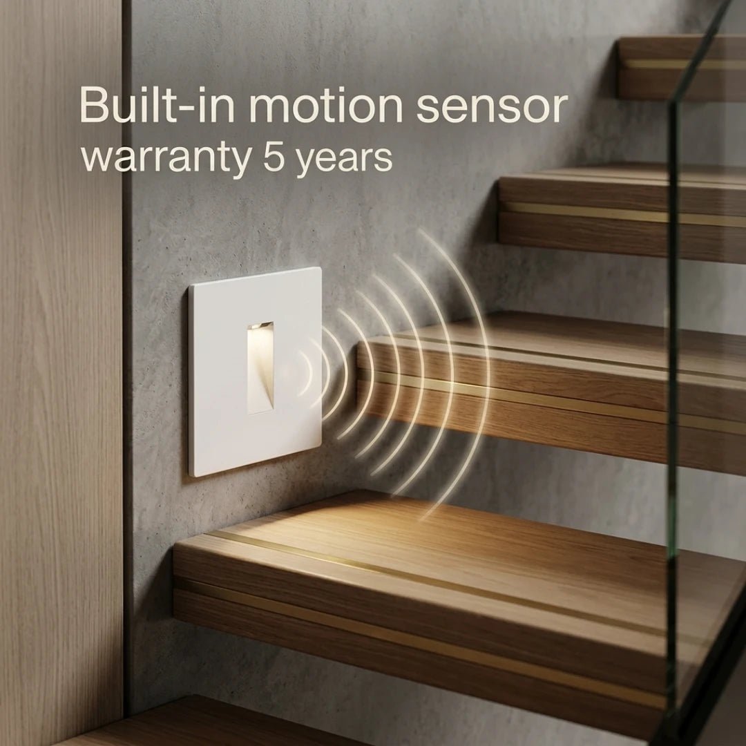 Light switch with built-in motion sensor and 5-year warranty text above wooden stairs.