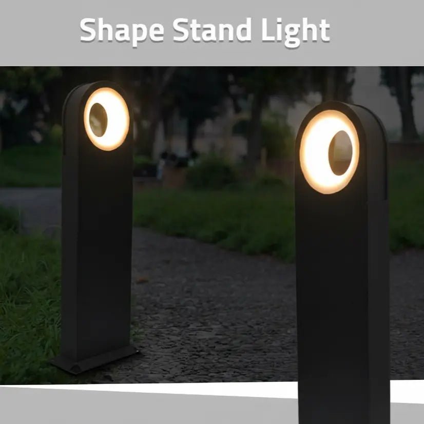 Two black stand lights with circular lights on top, placed outdoors.