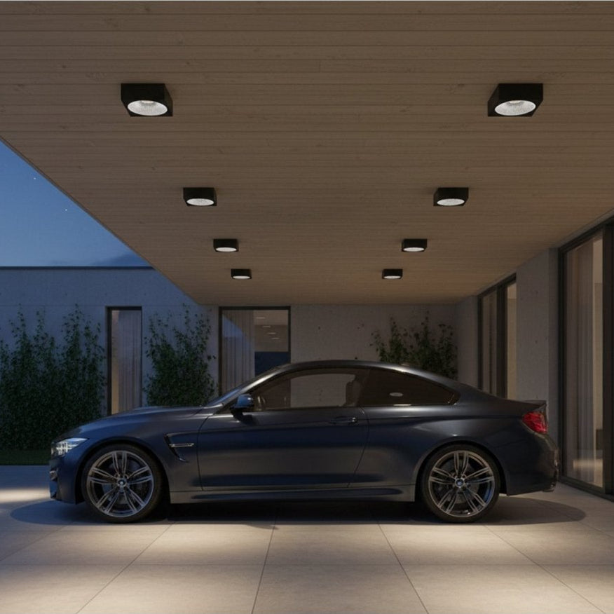 Modern car parked in front of a stylish house at night