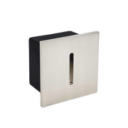 Square metal wall fixture with black and silver finish on a green background