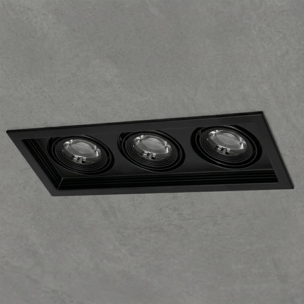 Black rectangular recessed light fixture on a gray concrete background
