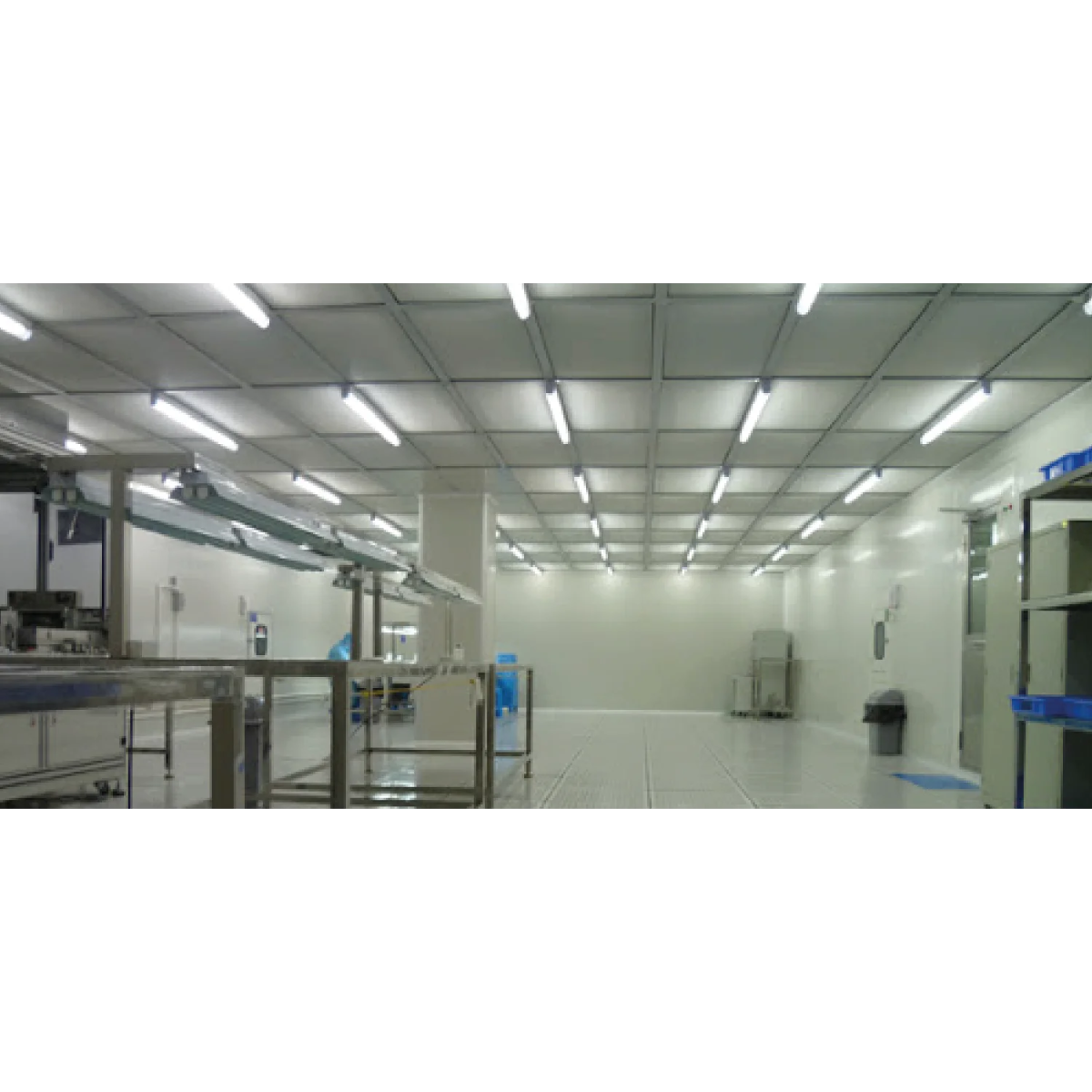 Cleanroom or laboratory with white walls, ceiling panels, and fluorescent lighting.