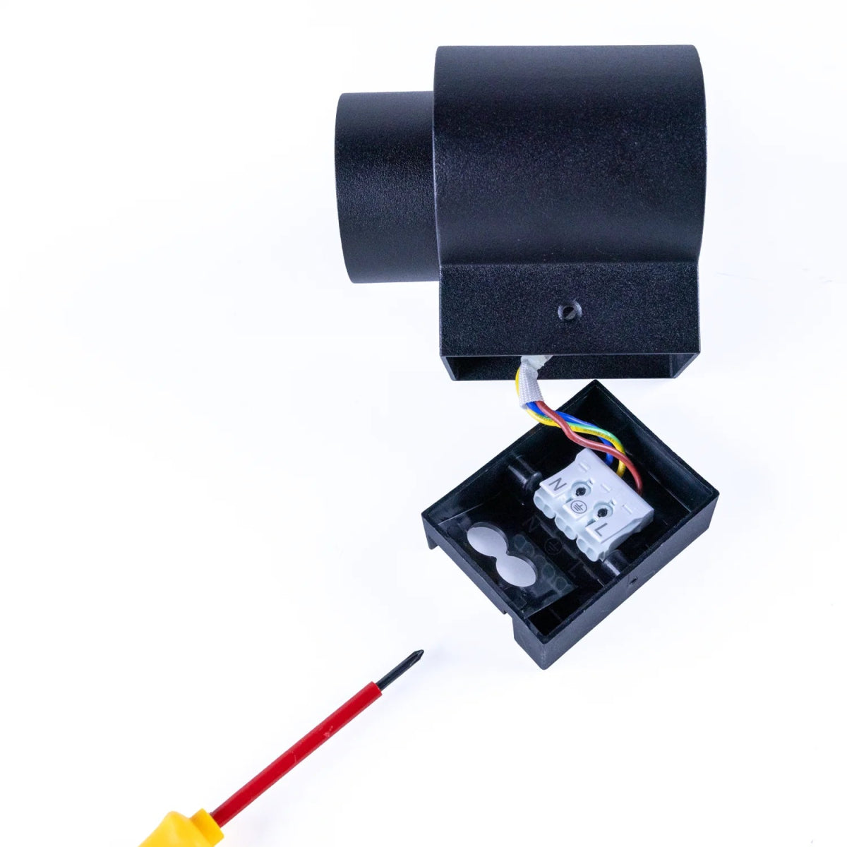 Black electronic device with wiring and a screwdriver on a white background