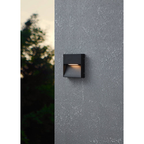 Ultralight Modern Wall Light (FYL0003) mounted on textured gray wall emitting soft warm LED light outdoors.