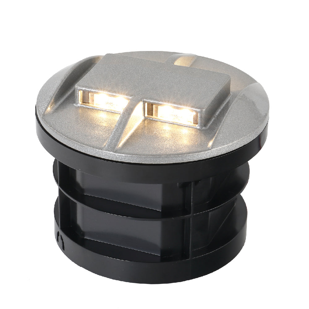 A black, cylindrical, ultra-light recessed ground lighting designed for outdoor use, with LED lights visible on the top.