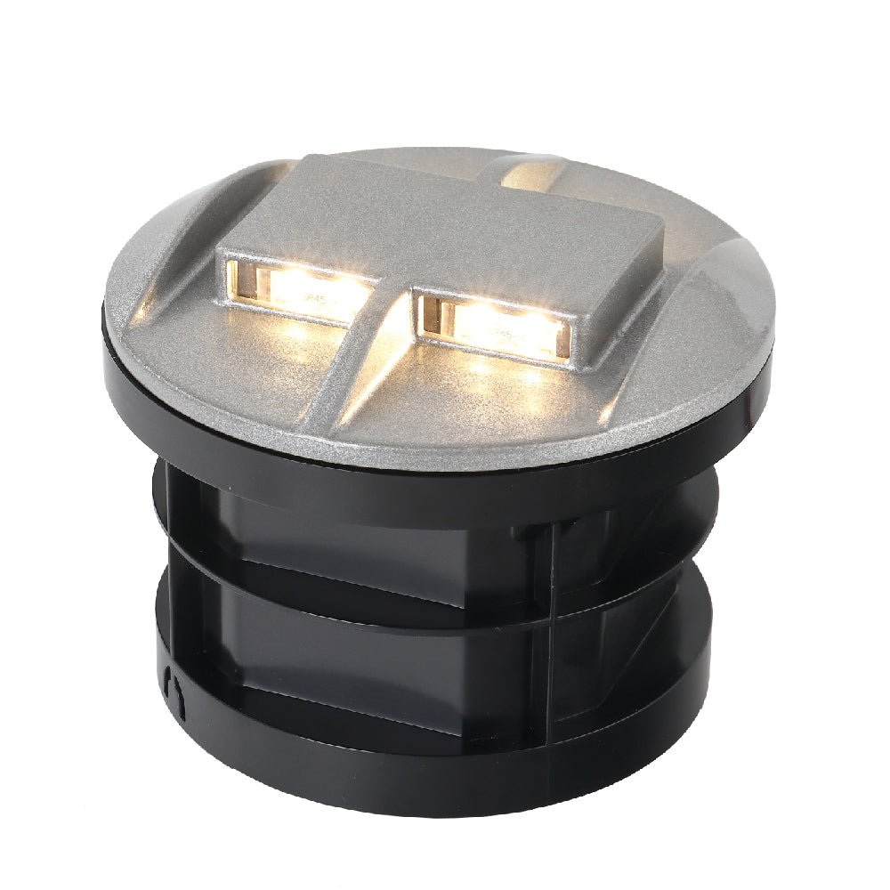 A black, cylindrical, ultra-light recessed ground lighting designed for outdoor use, with LED lights visible on the top.