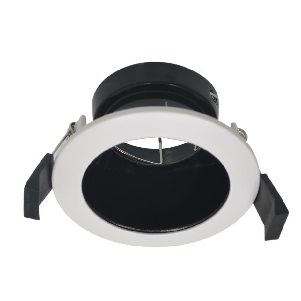 Recessed ceiling light with black interior and white exterior on a white background
